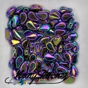 May include: A large pile of iridescent teardrop-shaped glass beads in shades of purple, blue, and green. The beads have a metallic sheen and are perfect for jewelry making.