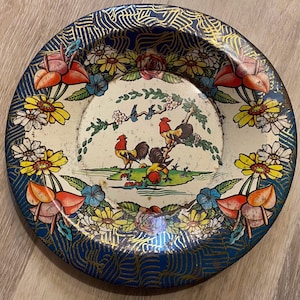 Vintage tin plate with 3 roosters and floral pattern.