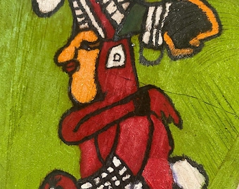 May include: A hand-painted wooden carving of a figure with a red body, white and black patterned clothing, and a colorful headdress. The figure is painted on a green background.