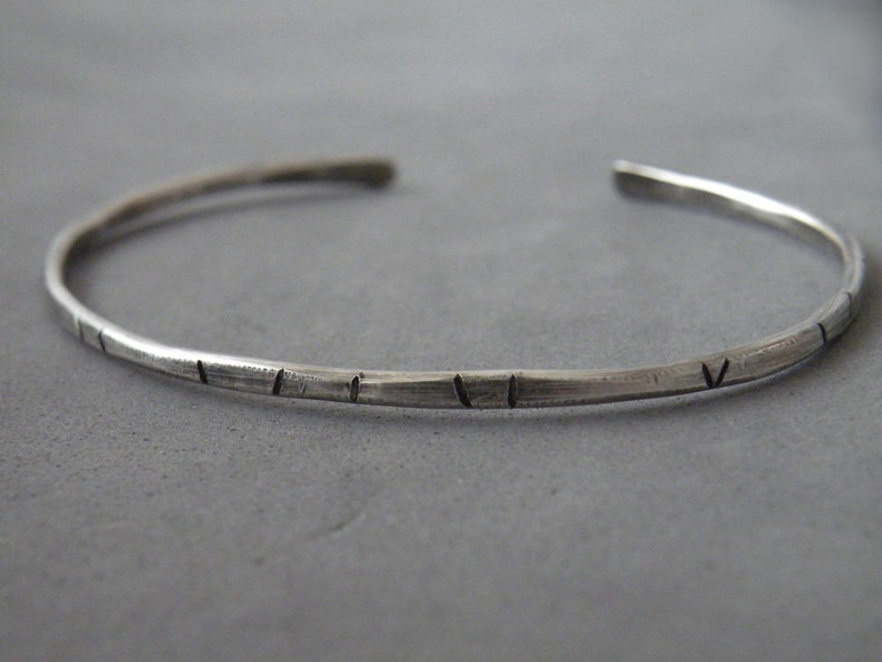 Unisex open cuff hammered for texture. The bracelet features random vertical lines which add personality to the piece. Available in 3 thickness(2mm, 2.5mm, 3mm) and in two finishes: silver or oxidized.