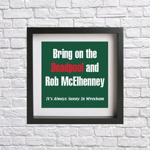 Könnte beinhalten: Ein gerahmter Druck mit grünem Hintergrund und weißem Text, der "Bring on the Deadpool and Rob McElhenney. It's Always Sunny In Wrexham." lautet.