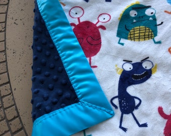 Beautiful blanket in an monster print in white, red and teal. So soft and cuddly .