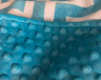 This blanket is a turguoise and white chevron in minky, the back is a turquoise minky dot .