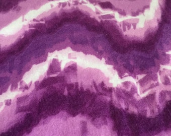 A tie dyed purple and white flannel fitted crib /toddler sheet
