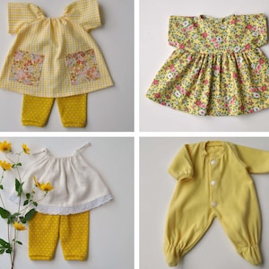 May include: Four different baby outfits in yellow and white. The first outfit is a yellow gingham dress with a matching pair of pants. The second outfit is a yellow floral dress. The third outfit is a white dress with a lace trim and a matching pair of yellow pants. The fourth outfit is a yellow onesie.