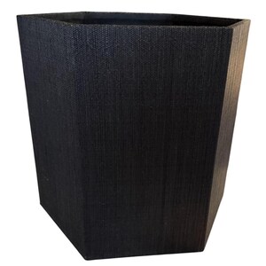 May include: A tall, black, hexagonal planter with a textured surface. The planter has a slightly tapered design, wider at the top and narrower at the base. The dark color and geometric shape give it a modern look, suitable for indoor or outdoor use.