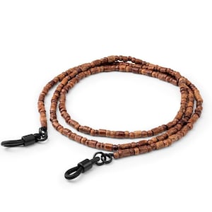 May include: A brown wooden beaded glasses chain with black metal clasps. The chain is made of small, round beads and is designed to hold glasses around the neck.