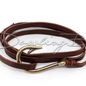 May include: A brown leather wrap bracelet with a gold-toned hook clasp.