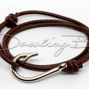 May include: A brown leather bracelet with a silver hook clasp. The bracelet is tied with a knot on one end.