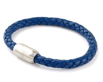 May include: A blue leather bracelet with a silver magnetic clasp. The bracelet is braided and has a simple design.