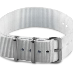 May include: White nylon watch strap with silver buckle and keepers.