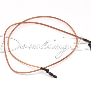 May include: A brown leather eyeglass chain with black metal clasps. The chain is looped and ready to be worn.