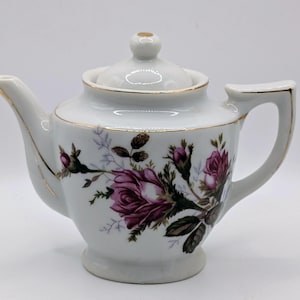 May include: A set of three ceramic nesting bowls in shades of blue, green, and white. The bowls feature a speckled design and varying sizes, perfect for food preparation or serving. The largest bowl measures approximately 8 inches in diameter.