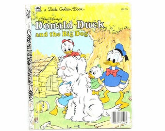 May include: A Little Golden Book featuring Donald Duck and the Big Dog. The cover shows Donald Duck and his nephews with a large white dog. The book is yellow with a red and blue title.