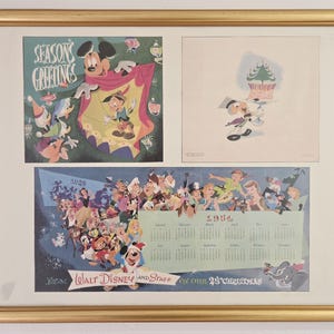 May include: Framed vintage Disney artwork featuring Mickey Mouse, Pinocchio, and other characters. The artwork includes a "Season's Greetings" image and a 1954 calendar with Disney characters. The frame is gold-colored.