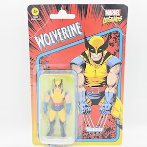 May include: A Wolverine action figure in a blister pack. The figure is yellow and blue, with claws extended. The packaging features a comic-style illustration of Wolverine and the text "Wolverine" and "Marvel Legends".
