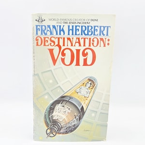May include: A vintage paperback book titled "Destination: Void" by Frank Herbert. The cover features a retro sci-fi illustration of a spacecraft and the book's title in large, bold letters. The book is set against a white background.