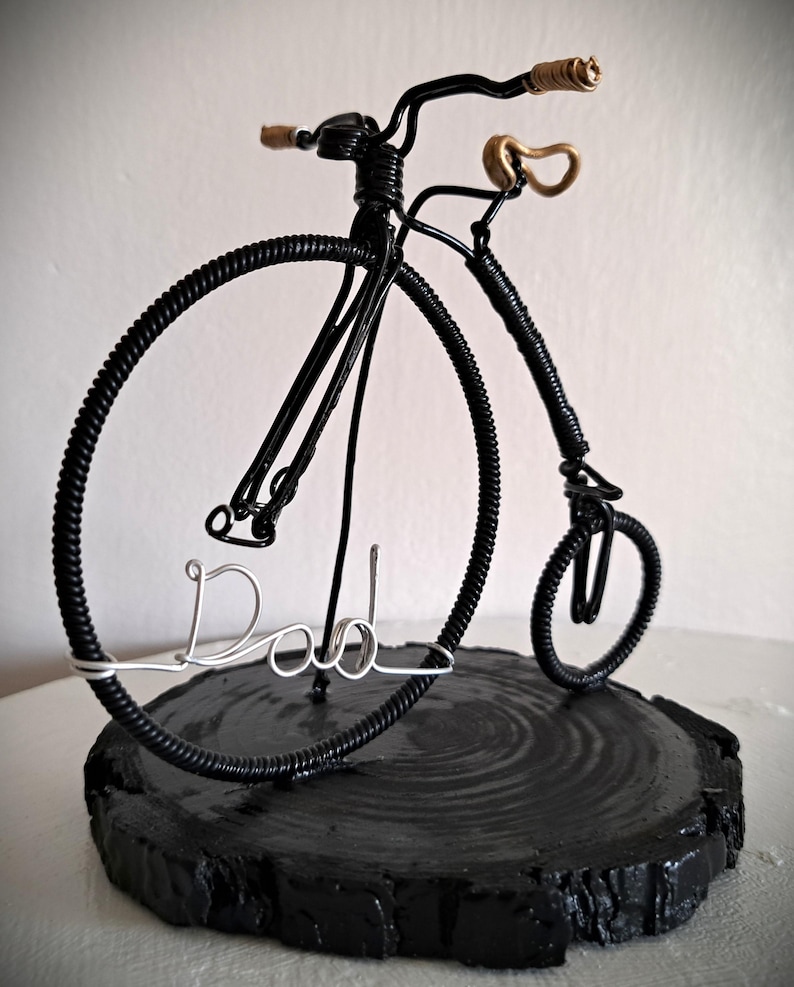 Black Penny Farthing bicycle sculpture with gold hand grips and gold seat