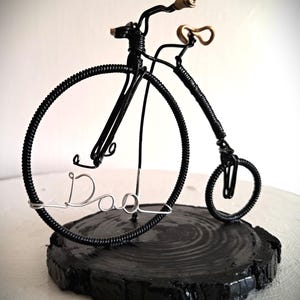 Black Penny Farthing bicycle sculpture with gold hand grips and gold seat
