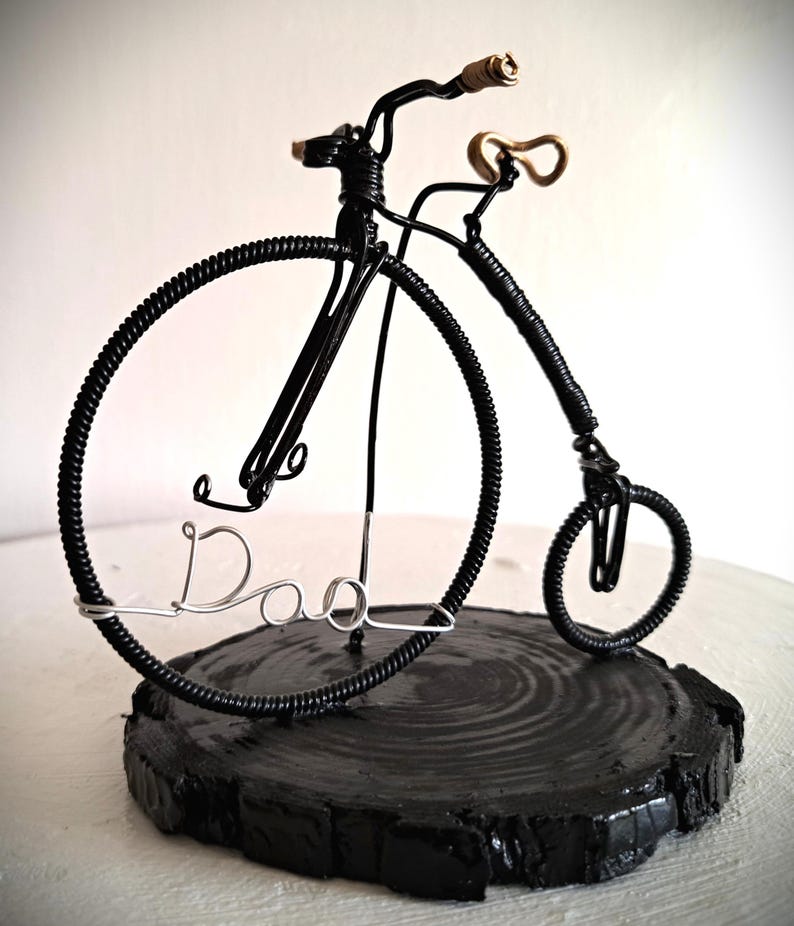 Black Penny Farthing bicycle sculpture with gold hand grips and gold seat