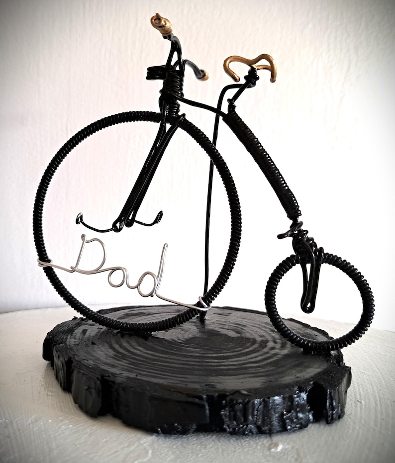 Black Penny Farthing bicycle sculpture with gold hand grips and gold seat