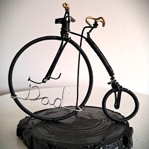 Black Penny Farthing bicycle sculpture with gold hand grips and gold seat