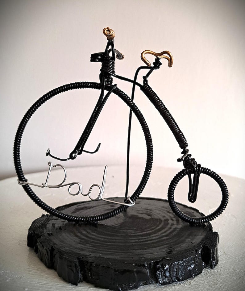 Black Penny Farthing bicycle sculpture with gold hand grips and gold seat