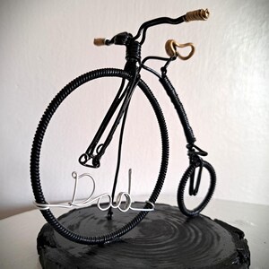 Black Penny Farthing bicycle sculpture with gold hand grips and gold seat