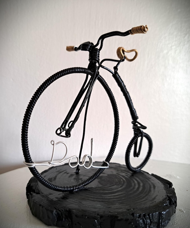 Black Penny Farthing bicycle sculpture with gold hand grips and gold seat