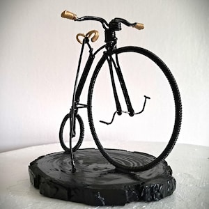 Black Penny Farthing bicycle sculpture with gold hand grips and gold seat