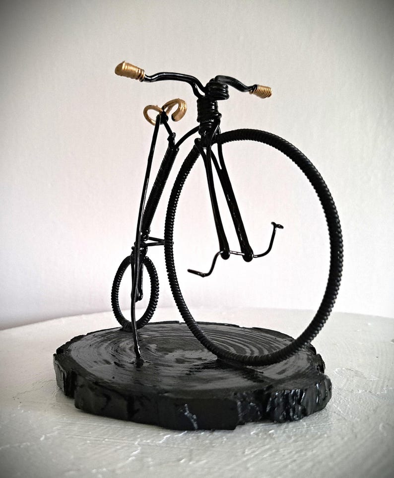 Black Penny Farthing bicycle sculpture with gold hand grips and gold seat