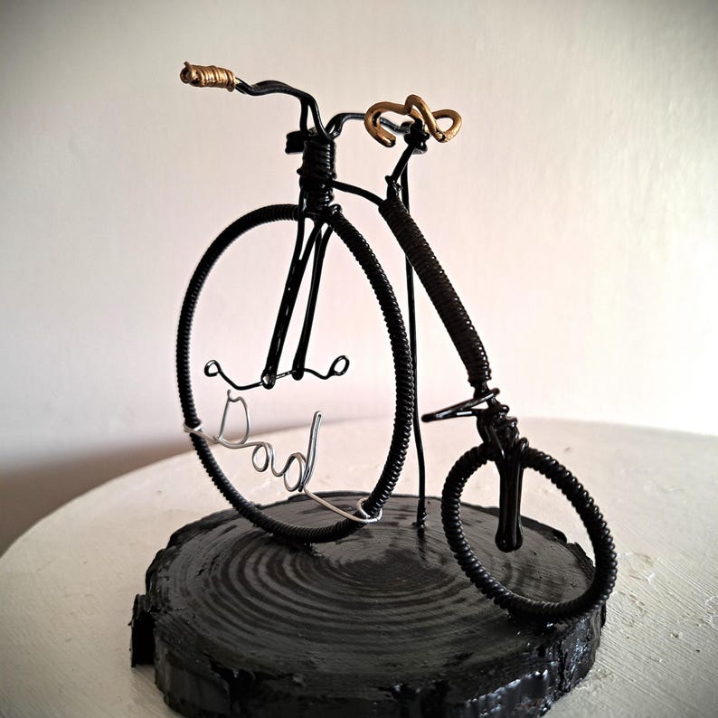 Black Penny Farthing bicycle sculpture with gold hand grips and gold seat