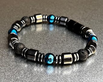 May include: A black and blue beaded bracelet with black lava rock beads, silver metal beads, and dark blue gemstone beads.