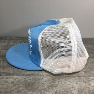 May include: A light blue and white mesh trucker hat with the text "GO AWAY" embroidered on the front.