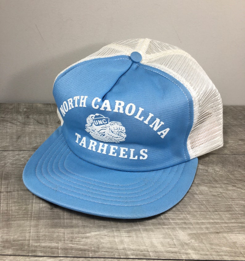 May include: A light blue and white trucker hat with the text "North Carolina Tarheels" and a UNC logo in white.