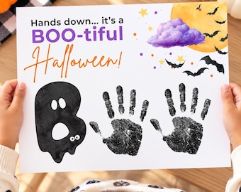 May include: A white rectangular paper featuring the text Hands down... it's a BOO-tiful Halloween! with a black ghost graphic, two black handprints, a yellow moon, a purple cloud, and black bats against a white background.