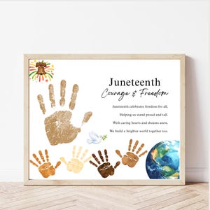 May include: A framed print celebrating Juneteenth, featuring a large handprint and smaller handprints in various skin tones. The text reads "Juneteenth Courage & Freedom" with a poem about freedom and unity. A bell and fireworks are in the upper left corner.