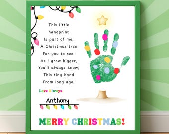 May include: A framed print with a green border features a handprint Christmas tree design. The handprint is green with colorful dots. Text includes a poem, the name "Anthony", and "MERRY CHRISTMAS!" in colorful letters. Decorative string lights are also included.