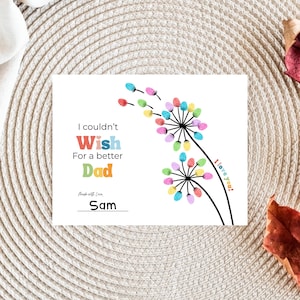 May include: A white greeting card with the text "I couldn't Wish For a better Dad." Colorful dandelion illustrations and the words "I love you!" are also featured. The card is signed "Sam."