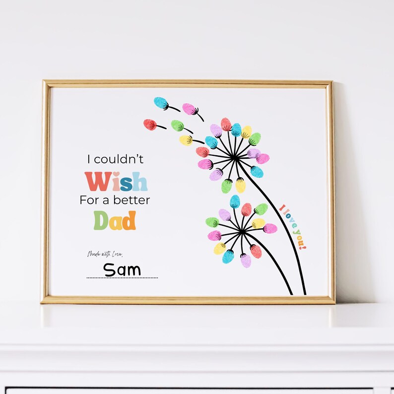May include: A framed print with a gold border features a colorful dandelion design. The text reads "I couldn't wish for a better Dad" with the name "Sam" at the bottom. The words "I love you!" are also included.