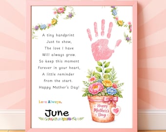 May include: A framed print with a pink border features a poem and a pink handprint. A floral arrangement in a pot and the words "Happy Mother's Day" are also included. The word "June" is written at the bottom.