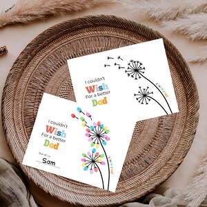 May include: Two white cards with dandelion designs and the text "I couldn't Wish For a better Dad." One card has colorful fingerprint accents and the name "Sam." The other card has a simple black and white design. Both cards say "I love you!"