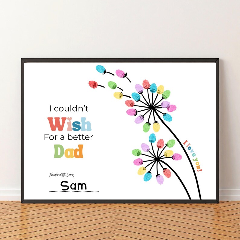 May include: Framed art print with a white background featuring colorful dandelion-like flowers. Text reads "I couldn't Wish For a better Dad" with the name "Sam" below. The phrase "I love you?" is also included.