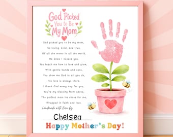 May include: A framed print with a pink border features a poem about motherhood, a pink handprint flower, and the text "Happy Mother's Day!". The artwork includes a pink flower pot with a heart, green leaves, and two bees.