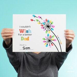 May include: A white print with the text "I couldn't Wish For a better Dad" in colorful letters. The print features a dandelion design with colorful accents and the words "I love you!" and "Made with Love, Sam".