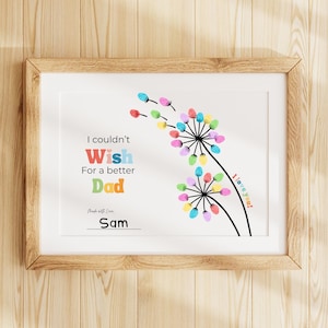May include: A framed print with a white background and a wooden frame. The print features colorful finger-painted flowers and the text "I couldn't wish for a better Dad." The name "Sam" is written at the bottom, with the words "I love you!" on the right.