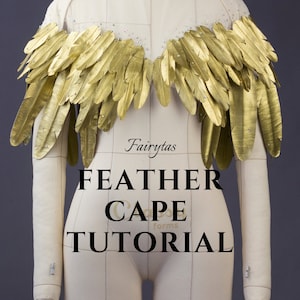 May include: A gold feather cape tutorial by Fairytas Cape Forms. The cape is made of gold feathers and is worn on a white dress form.