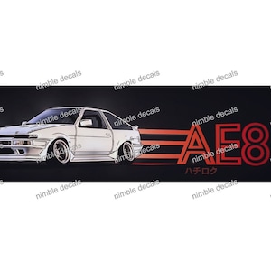 May include: White sports car illustration with the text "AE86" in red, along with Japanese characters. The design is set against a black background, with the words "nimble decals" repeated.