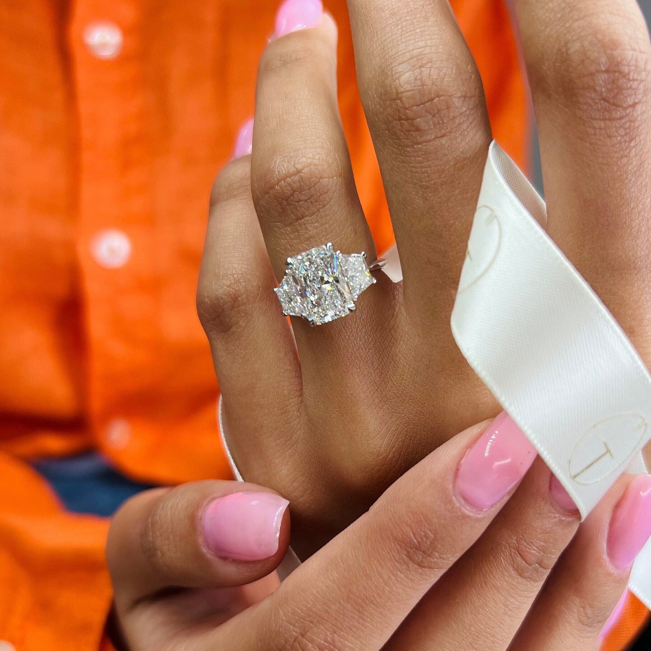 Round diamond with on sale trapezoid side stones