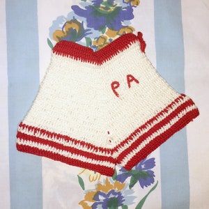 May include: White crocheted shorts with red trim and the letters "PA" embroidered in red.